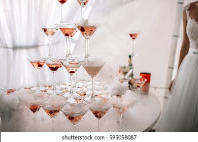 Champagne glasses. Wedding slide champagne for bride and groom. Colorful wedding glasses with champagne. Catering service. Catering bar for celebration. Beauty of bridal interior for wedding
