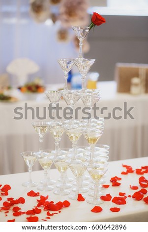 Champagne glasses. Wedding slide champagne for bride and groom. Colorful wedding glasses with champagne. Catering service. Catering bar for celebration. Beauty of bridal interior for wedding