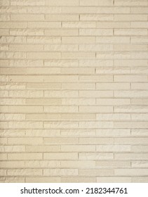 Champagne Gold Colored Brick Tile Wall Texture Background. Luxury Brickwork Pattern Backdrop.