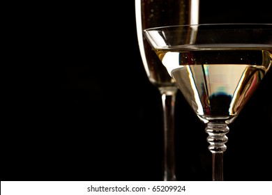 Champagne And Martini Glasses Over Black Background