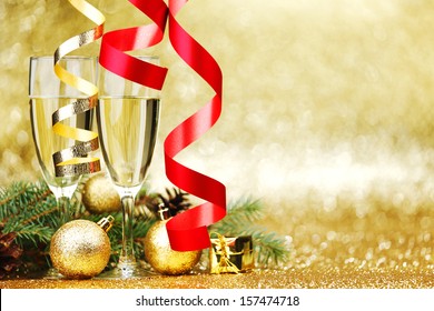Champagne and new year decoration on golden background