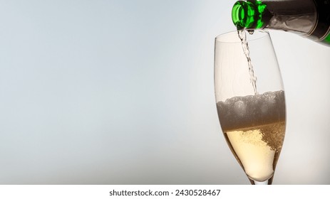 champagne is poured into a glass with free space for text - Powered by Shutterstock