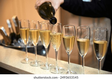 champagne is poured into glasses on the table - Powered by Shutterstock