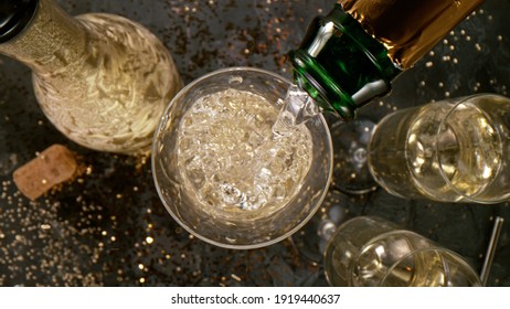 Champagne Pouring In A Glass From A Bottle, Top View, Close-up