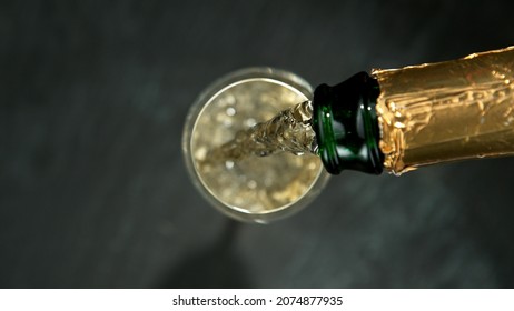 Champagne Pouring In A Glass From A Bottle, Top View.