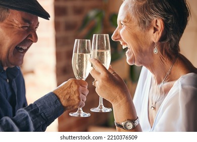 Champagne, toast and elderly couple laugh and relax, bond in celebration of anniversary or retirement in their home together. Love, happy and success with senior man and woman cheers to relationship - Powered by Shutterstock