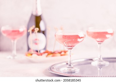 Champagne or wine in glasses on light background. Copy space.