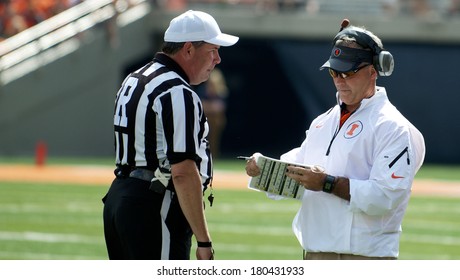 CHAMPAIGN,IL-SEPTEMBER 28: University Of Illinois Head Football Coach Tim Beckman Converses With An Official During A Time Out On Saturday, Sept 28, 2013.