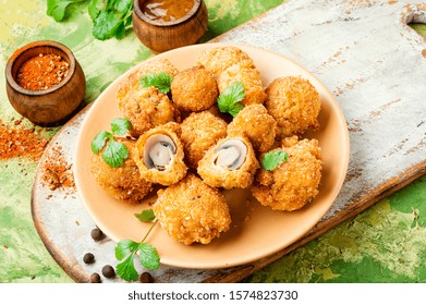 Champignon mushrooms in breadcrumbs.Breaded mushrooms or deep-fried mushrooms - Powered by Shutterstock