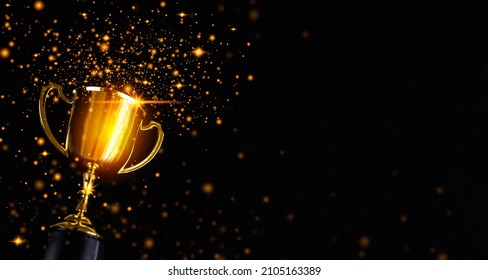 Champion golden trophy isolated on black background. Concept of success and achievement. - Powered by Shutterstock