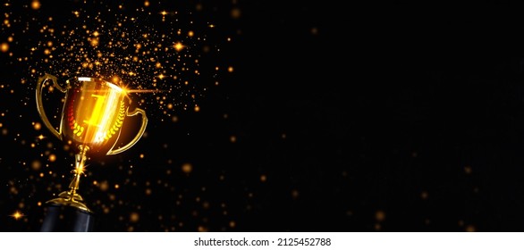 Champion golden trophy isolated on black background. Concept of success and achievement.Champions award, sport victory, winner prize concept. Competition success, first place, best win symbol. - Shutterstock ID 2125452788
