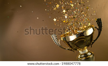 Champion golden trophy isolated on black background. Concept of success and achievement.