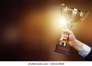 champion golden trophy placed on wooden table
    
    - Image - Shutterstock ID 1331157833