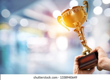 Champion golden trophy for winner background. Success and achievement concept. Sport and cup award theme. - Shutterstock ID 1338940649