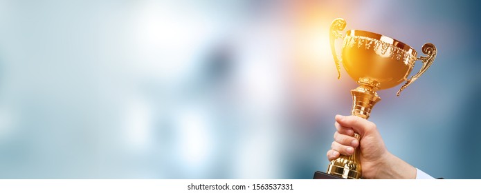 Champion golden trophy for winner background. Success and achievement concept. Sport and cup award theme. - Shutterstock ID 1563537331
