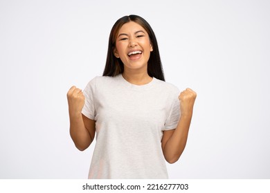 I am champion. Motivated enthusiastic girl screaming for joy and raising high her fists, celebrating successful winning, incredible victory. Studio shot isolated on white background  - Shutterstock ID 2216277703