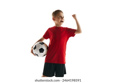 Champion. Young boy as soccer player in sportwear clenched fist holds football ball against white studio background. Concept of professional sport, championship, youth league, hobby. Ad - Powered by Shutterstock