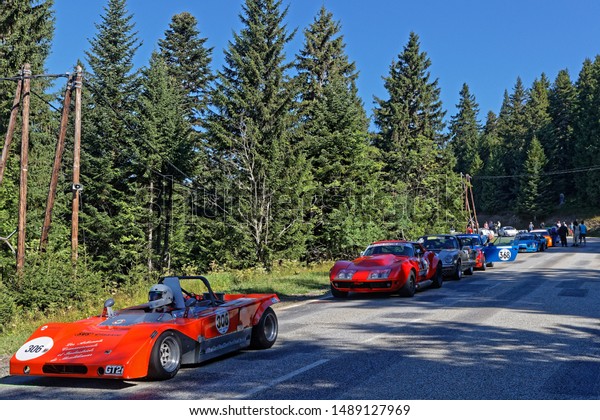 CHAMROUSSE, FRANCE, August\
25, 2019 : Historic racing cars drive to the start of uphill race,\
counting for French Championship, and leave the mountain resort of\
Chamrousse.
