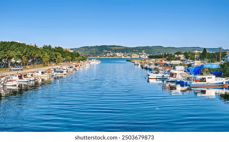 Chanakkale, Turkey, fishing boats stand on the pier, view of the city and the Dardanelles Strait - Powered by Shutterstock