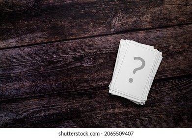 Chance cards, gambling, FAQ or unanswered questions Concept.
A stack of playing cards, printed with a question mark, on a rustic wooden background. Table top view, flat lay, copy space. - Powered by Shutterstock