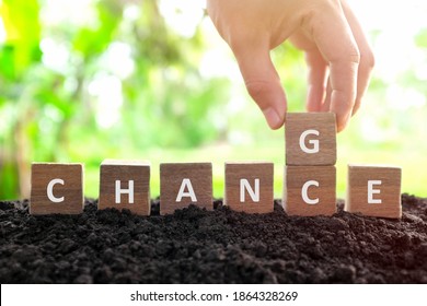 Chance to change, new opportunity, optimism and career growth concept. Male hand changing or flipping word chance to change wooden blocks dice in natural background. 