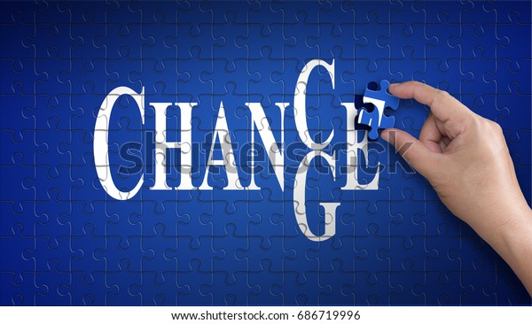 chance to change word on Jigsaw puzzle -\
business concept. Man hand holding a blue puzzle to complete the\
word divided over them concept of the solution to a problem,\
challenge, plan and\
strategy.