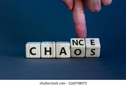 Chance or chaos symbol. Businessman turns wooden cubes and changes the word 'chaos' to 'chance'. Beautiful grey table, grey background, copy space. Business, chaos or chance concept.