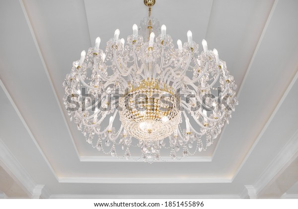 chandelier Palace\
Interior architecture background. Luxury expensive chandelier\
hanging under ceiling in palace. Luxurious crystal chandelier found\
in a rich manor\
house.