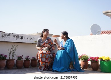 Chandigarh, Chandigarh  India - 03 03 2022  : Two Indian Girl Wearing Traditional Indian Wearing Sitting And Talking About Making Sweater