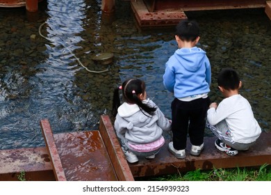 Changchun, Jilin - April 3 2021: Kids Are Checking A Water Mill In A Park.