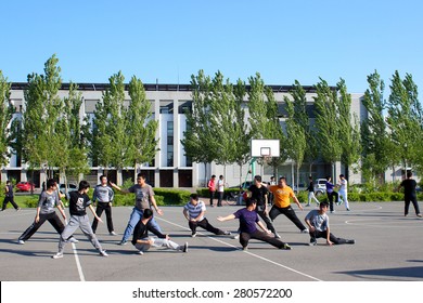 CHANGCHUN, JILIN, CHINA - MAY 21,2015 - Male Students In A Public University Practice Tai Chi Chuan During Their Physical Education Class On May 21, 2015.