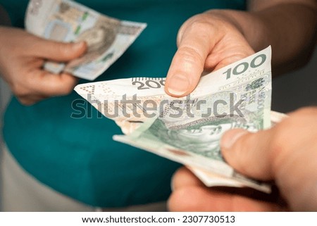 Change of the 500 plus social program in Poland Increasing the benefit 800 plus for each child Helping the family A woman holds PLN 500 in her hand and receives an additional PLN 300 social assistance