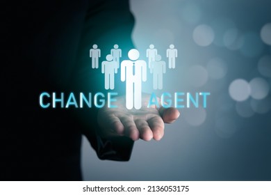 Change Agent Concept Of Transformational Leaders, Transforming Organizations To Success, Thinking Processes And Analyzing Business Leaders. Businessman Holding A Human Icon With Word Change Agent.