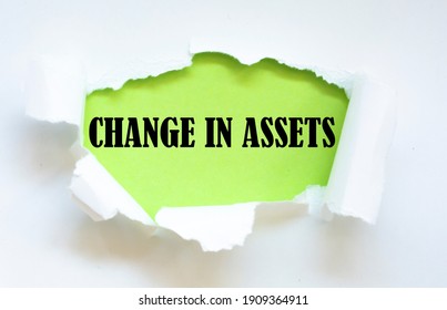 CHANGE IN ASSETS Message Written Under Torn Paper.