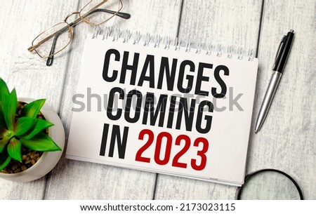 change is coming in 2023 word on notebook and calculator