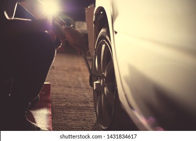 Change A Flat Car Tire  With Tire Maintenance, Damaged Car Tyre At Night.