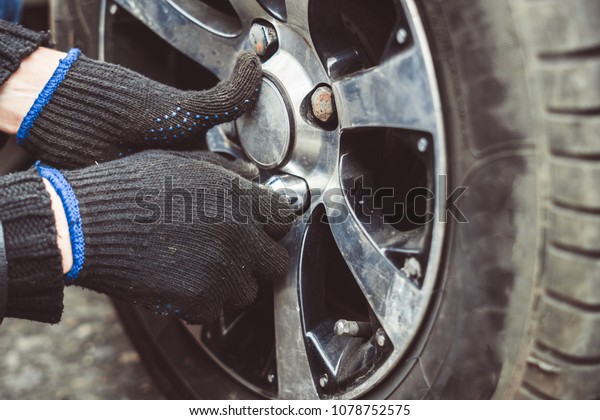 Change a flat car tire on road with Tire\
maintenance, damaged car\
tyre