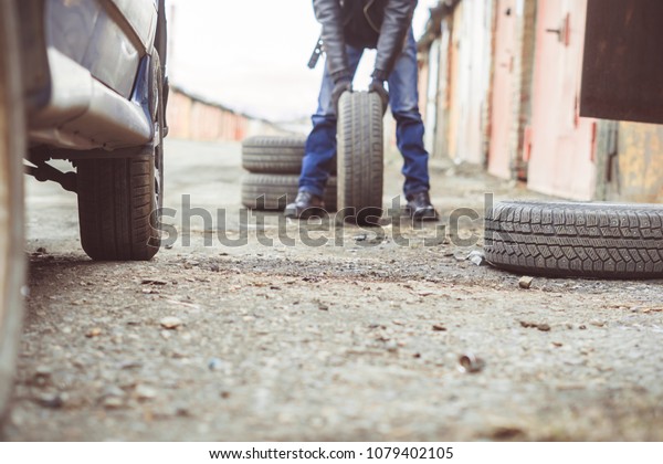 Change a flat car tire on road with Tire\
maintenance, damaged car\
tyre