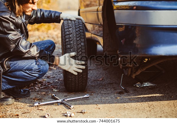 Change a flat car tire on road with Tire
maintenance, damaged car
tyre