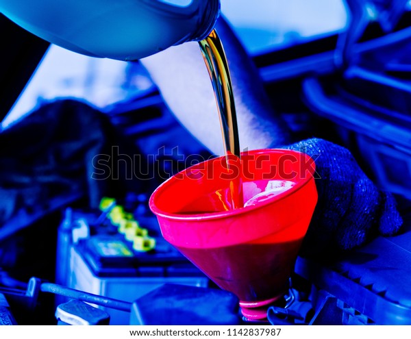 change oil car engine,\
filling the engine oil, new oil into car, pouring fresh oil,\
service car station\
