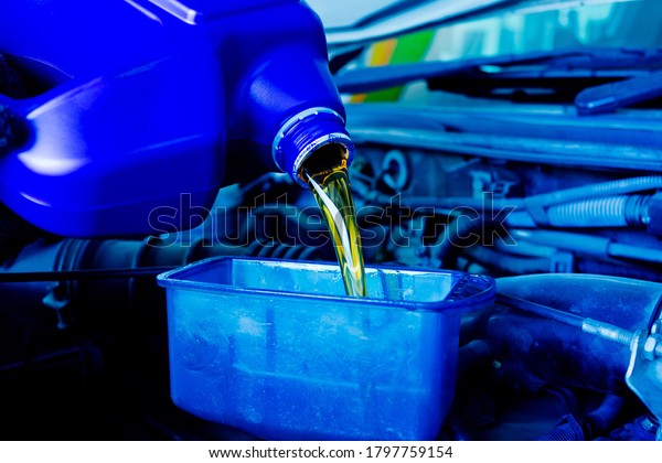 change oil car\
engine, filling the engine\
oil\
