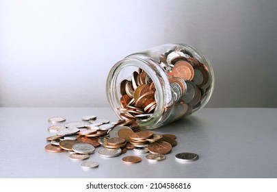 Change Spilling Out Of Glass Jar On Counter