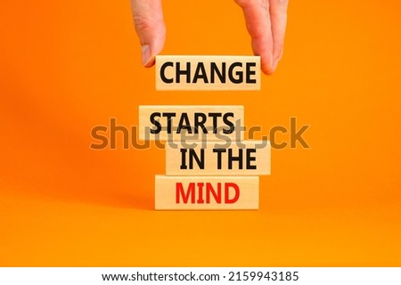 Change starts in the mind symbol. Concept words Change starts in the mind on wooden blocks on a beautiful orange table orange background. Business, motivational and change starts in the mind concept.