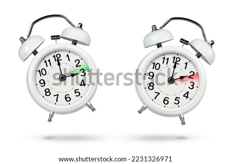 Change time. Winter and summer time concept isolated on white background. Change the time in spring and autumn, a white alarm clock indicates a change in time one hour ago, one hour ahead.