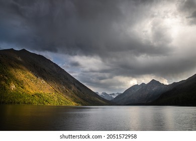change of weather on a high-mountain lake surrounded by mountains