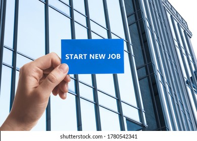 Change Your Life. Woman Holding Card With Text Start New Job Against Modern Building, Closeup