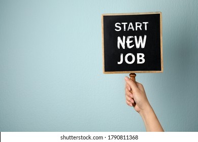 Change Your Life. Woman Holding Blackboard With Text Start New Job On Light Blue Background, Closeup. Space For Text