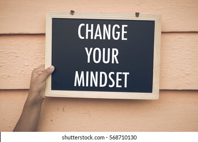 CHANGE YOUR MINDSET wording on chalk board with wooden background. Motivation, positive wishes, business, finance, education concept - Shutterstock ID 568710130