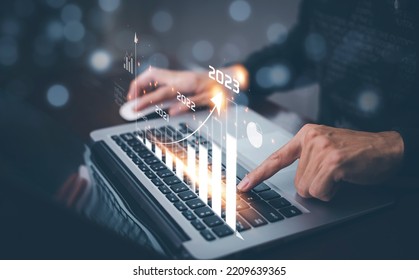 Changes in new planning, Hand using laptop with number 2023 new year, start new year concept digital trends,industry and business trend, strategy, investment, business planning and happy new year 