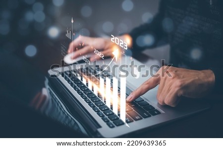 Changes in new planning, Hand using laptop with number 2023 new year, start new year concept digital trends,industry and business trend, strategy, investment, business planning and happy new year 